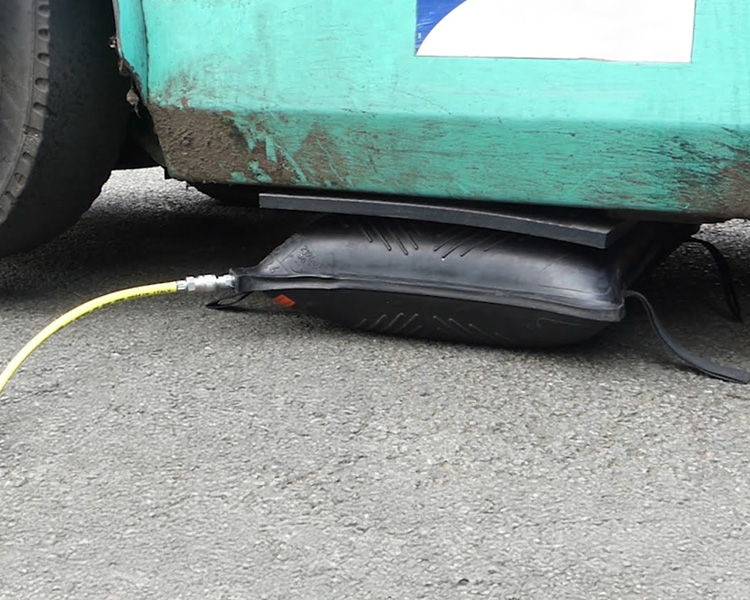 Simplex air bag in use lifting a forklift in an industrial environment.